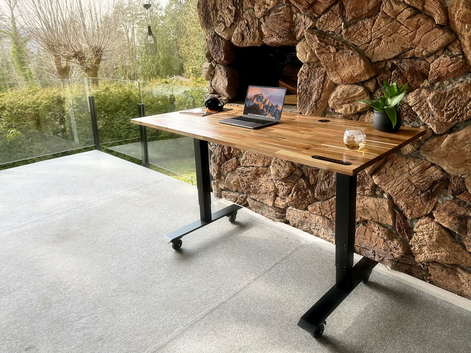 a wooden table with a laptop on top of it